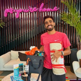 a man smiling with gifts