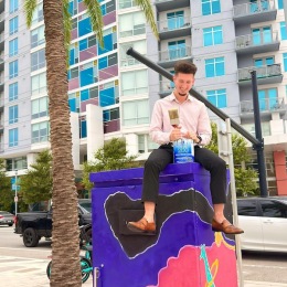 a man sitting on a box with paint
