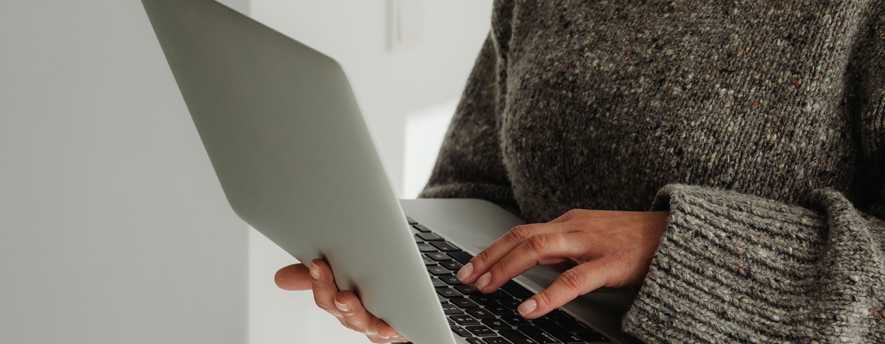 A person holding a laptop.