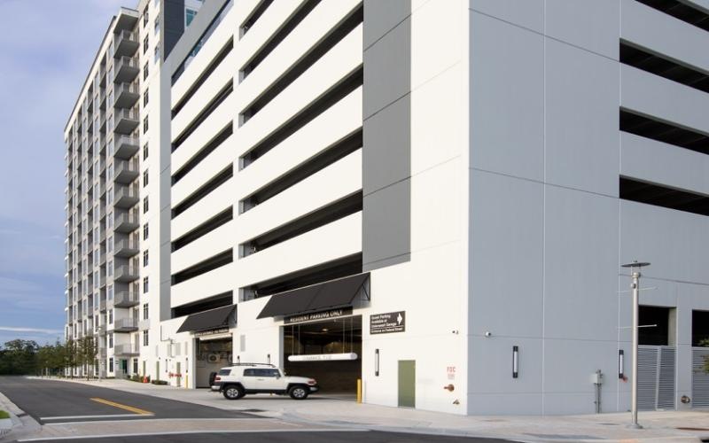 a white building with a car parked in front of it